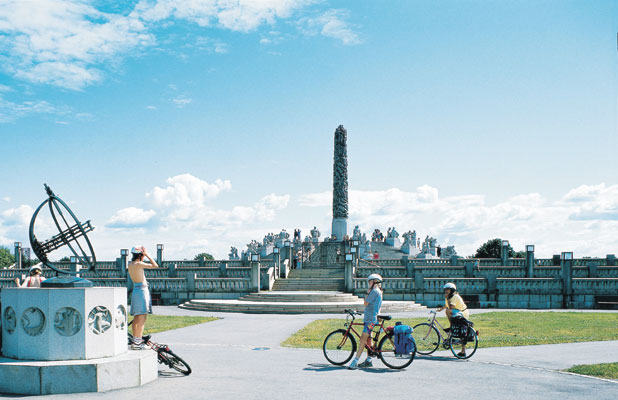 Oslo towns cities Vigeland Sculpture Park The Monolith and the sundial young boys on bicycle tour nature culture activity, Norwegen