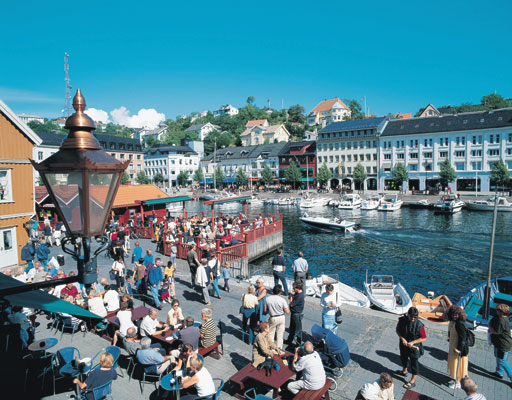 Arendal town cities towns Round a picturesque and lively harbour - Pollen - the buildings rise in terraces up the hills wharf quay people, Norwegen